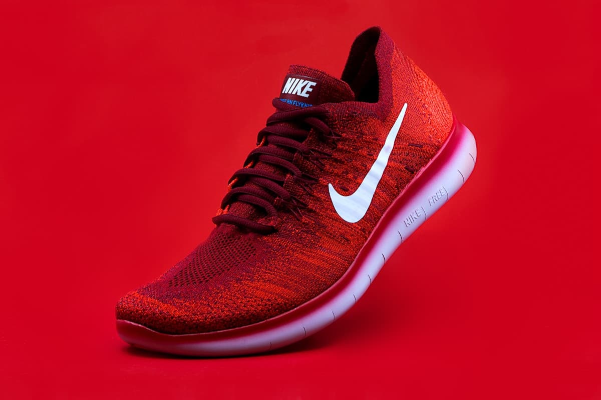 Red sneaker on a bold studio backdrop before background removal
